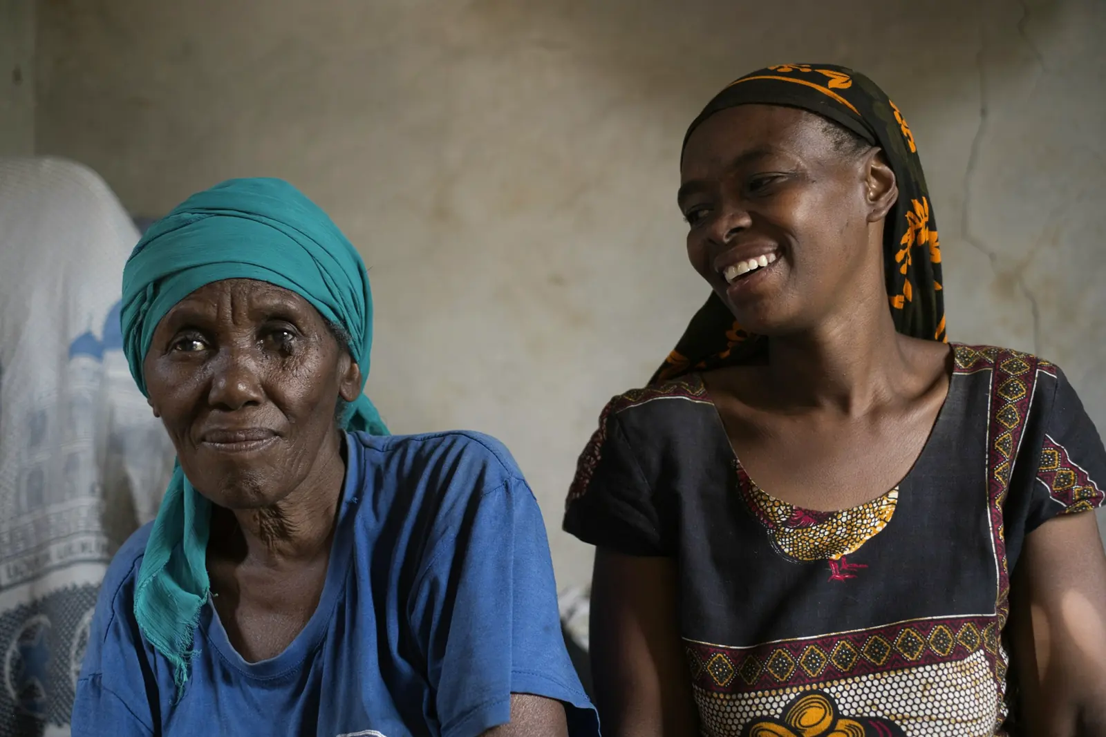 A mother and daughter laughing together at home
